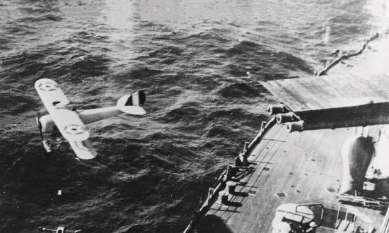 Nieuport 28 aircraft taking off from a platform atop a 14-inch gun turret on a U.S. battleship about 1921